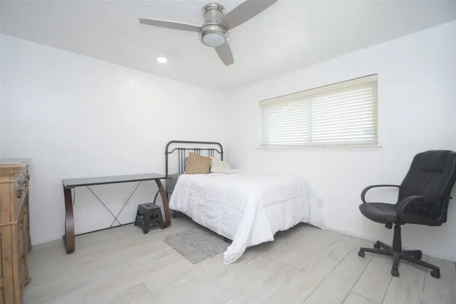 a spacious bedroom with a bed and window