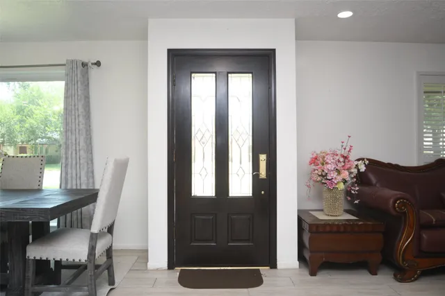 a dining room with furniture a chandelier and wooden floor