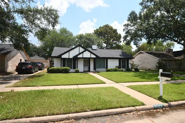 a front view of house with yard and green space