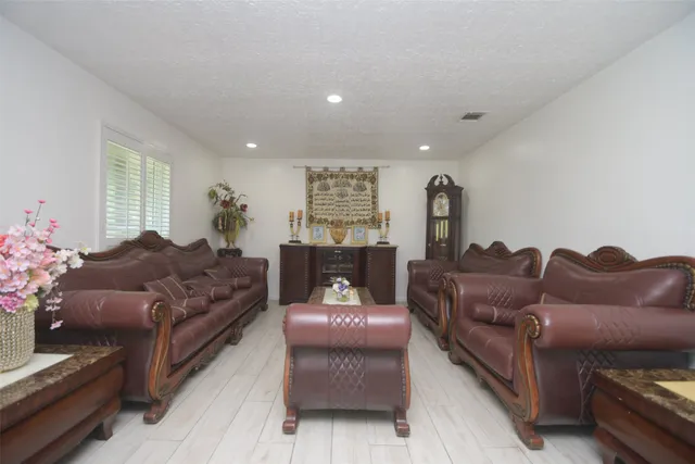 a living room with furniture and a potted plant