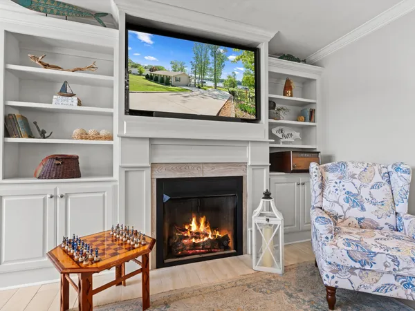 a living room with a fireplace and a floor to ceiling window