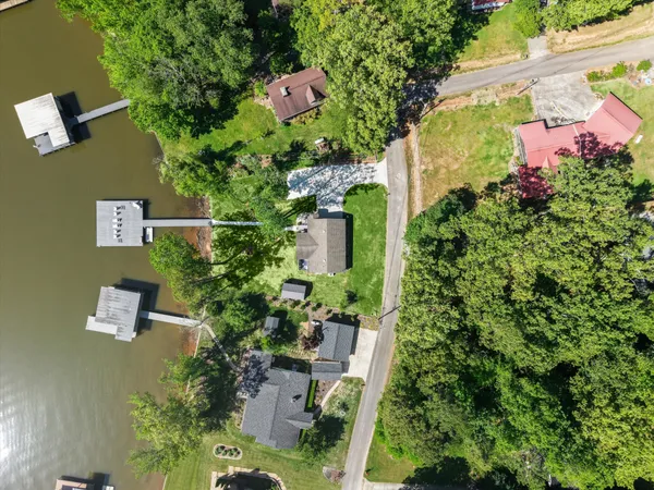 an aerial view of a house with yard