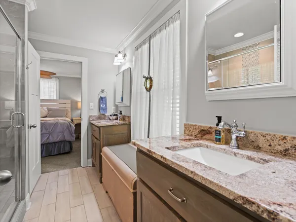a en suite bathroom with a granite countertop double vanity