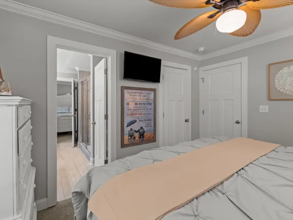 a bedroom with a bed and a flat screen tv