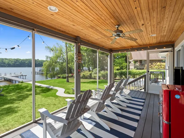 a view of a patio with a table chairs and a yard