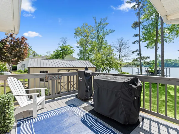 a view of a deck with wooden floor and outdoor seating