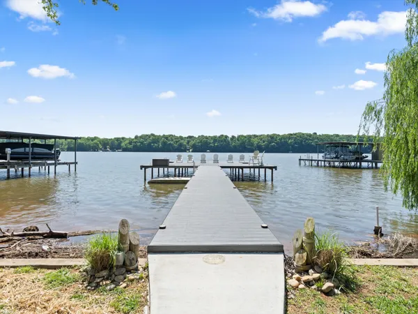 a view of a lake with boats and trees in the background