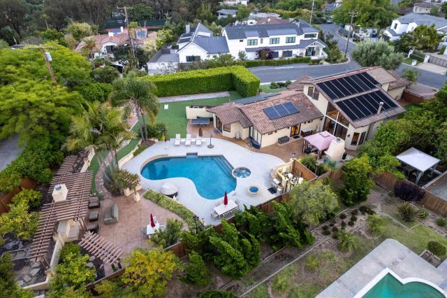 an aerial view of house with yard swimming pool and outdoor seating