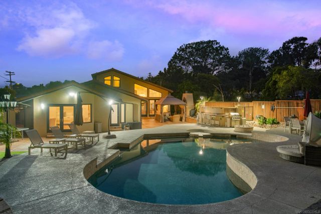 a view of a swimming pool with sitting area