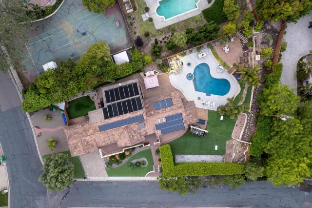 an aerial view of a house with a swimming pool