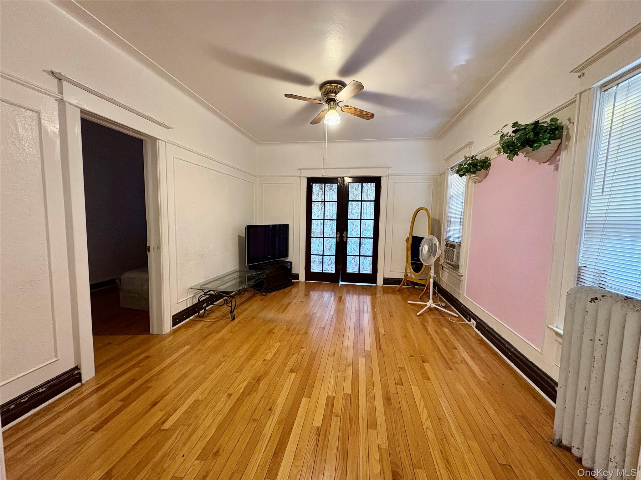 36 Eldert Lane, Unit 2 Queens, NY 11421 - Photo 1 of 1 a view of empty room with wooden floor and fan