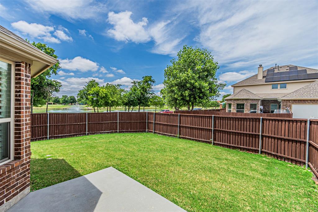 1805 Stetson Way Allen, TX 75002 - Photo 20 of 22 Expansive backyard featuring a manicured lawn, a concrete patio, and a privacy fence