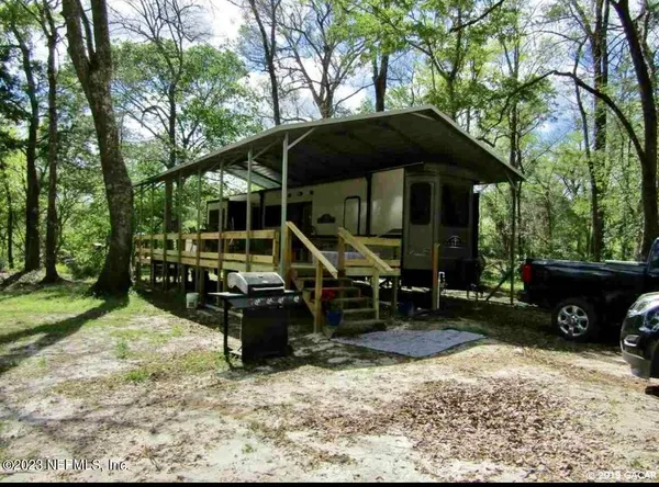 a view of a wooden deck and backyard