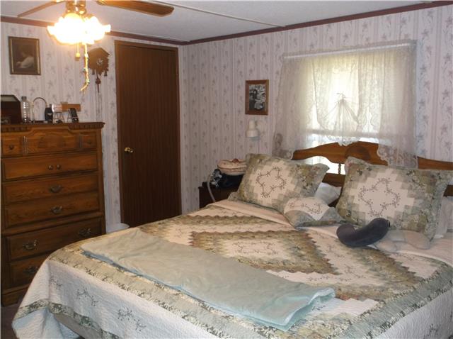 127 Sparrow Road Lafayette, TN 37083 - Photo 6 of 12 Large master bedroom with walk in closet and private bath.