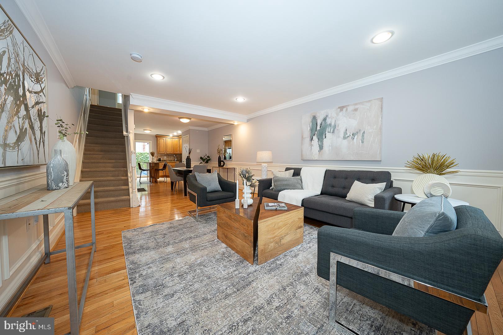 a living room with furniture and wooden floor