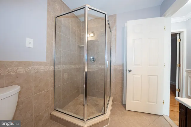 a bathroom with a glass shower door