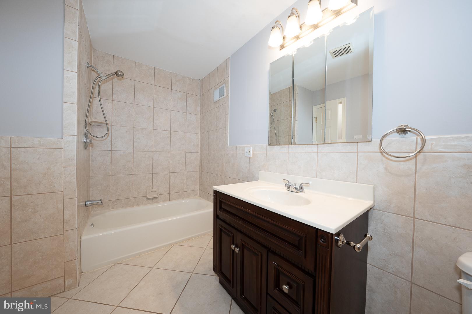 2406 Catharine Street Philadelphia, PA 19146 - Photo 20 of 37 a bathroom with a sink vanity tub and shower