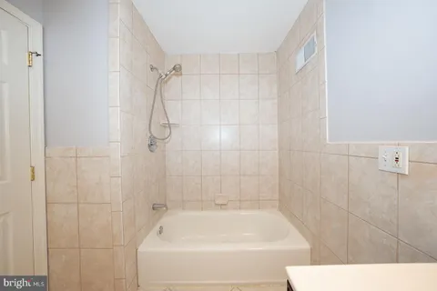 a bathroom with a shower and a bath tub