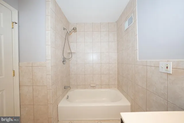 a bathroom with a shower and a bath tub