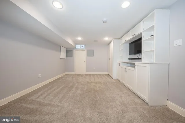a view of an empty room with a kitchen