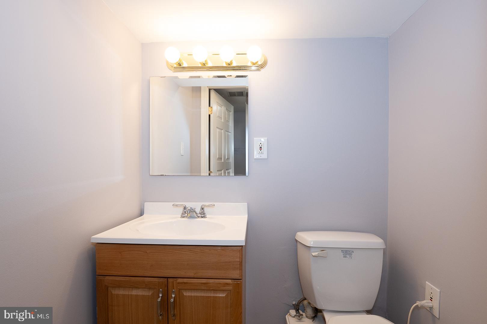 2406 Catharine Street Philadelphia, PA 19146 - Photo 27 of 37 a bathroom with a toilet sink and mirror