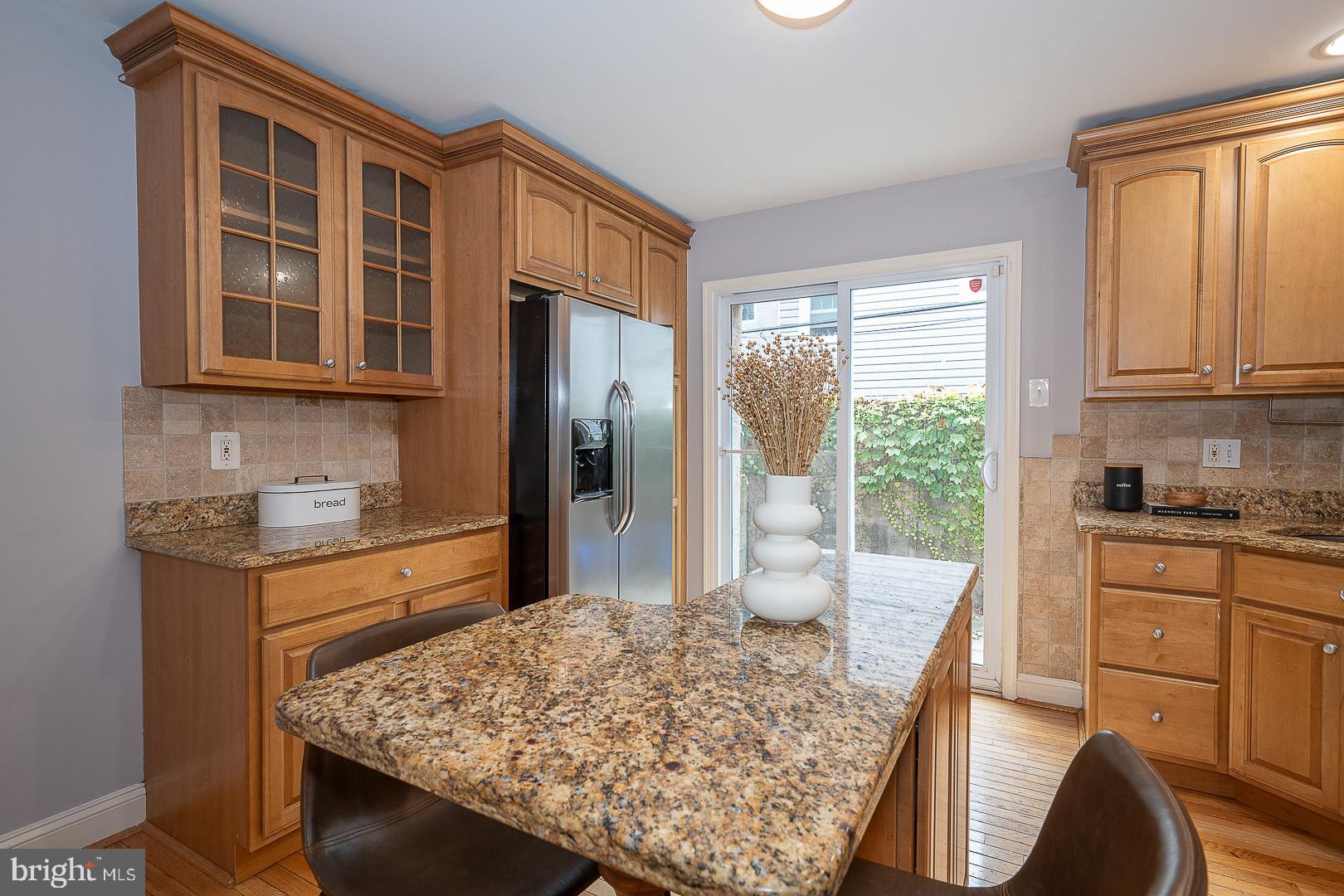 2406 Catharine Street Philadelphia, PA 19146 - Photo 9 of 37 a kitchen with stainless steel appliances granite countertop a stove a sink dishwasher and wooden cabinets with wooden floor