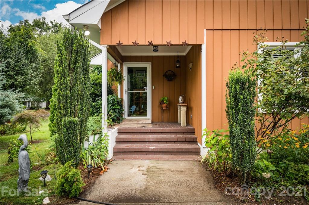 10900 Flat Iron Road Charlotte, NC 28226 - Photo 1 of 44 a view of a house with potted plants and a fountain