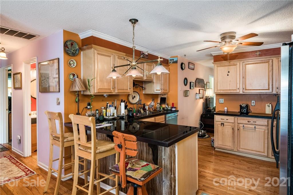 10900 Flat Iron Road Charlotte, NC 28226 - Photo 12 of 44 a kitchen with stainless steel appliances a stove a sink and a refrigerator