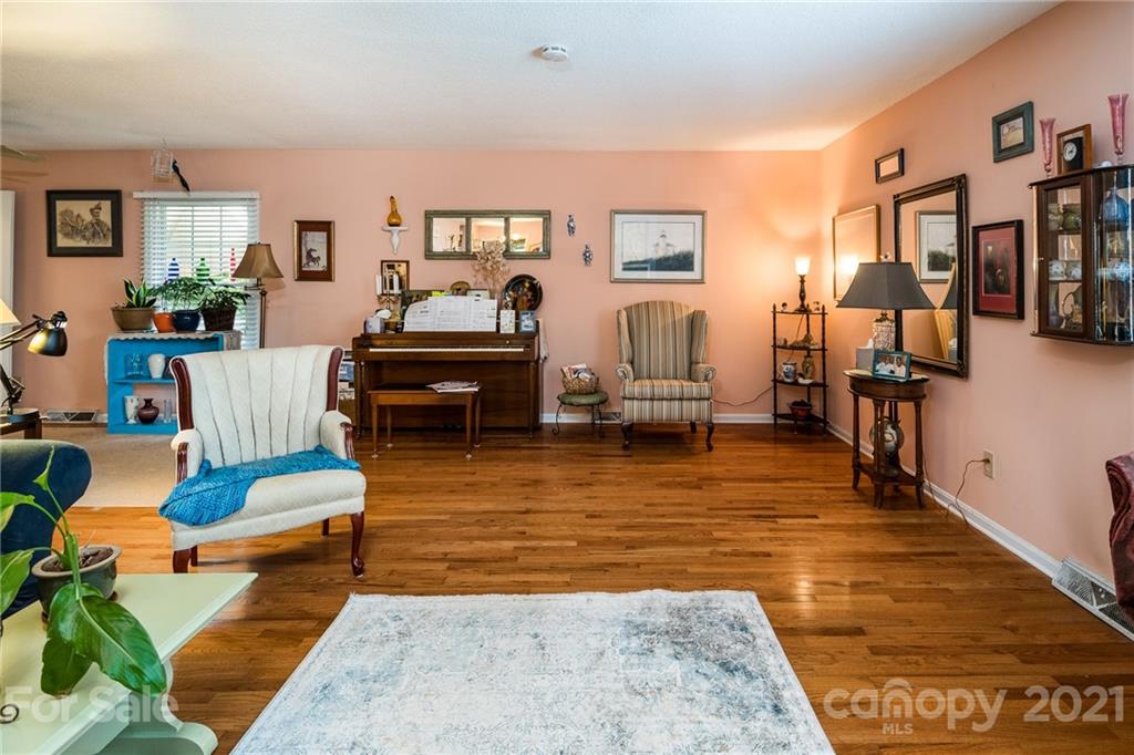 10900 Flat Iron Road Charlotte, NC 28226 - Photo 14 of 44 a living room with furniture and a wooden floor