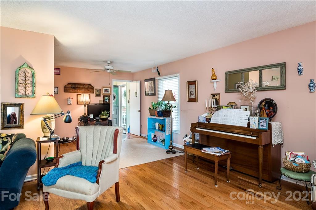 10900 Flat Iron Road Charlotte, NC 28226 - Photo 15 of 44 a living room with furniture a wooden floor and a table