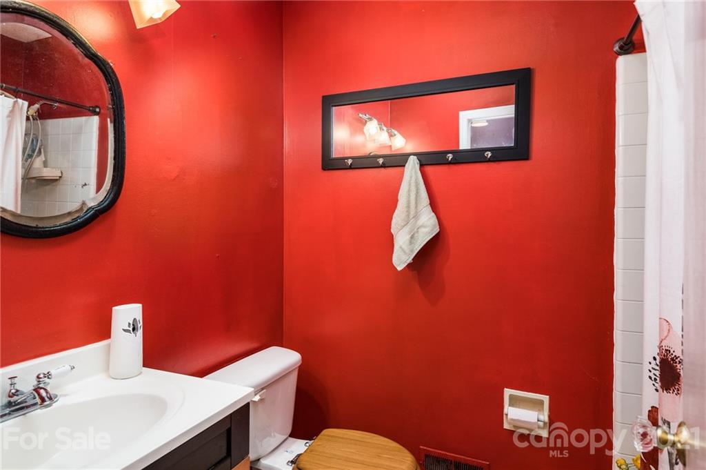 10900 Flat Iron Road Charlotte, NC 28226 - Photo 22 of 44 a bathroom with a toilet sink and mirror
