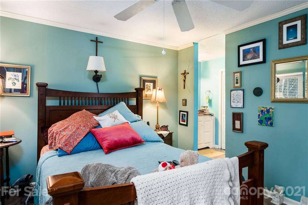 10900 Flat Iron Road Charlotte, NC 28226 - Photo 23 of 44 a bedroom with furniture and a lamp