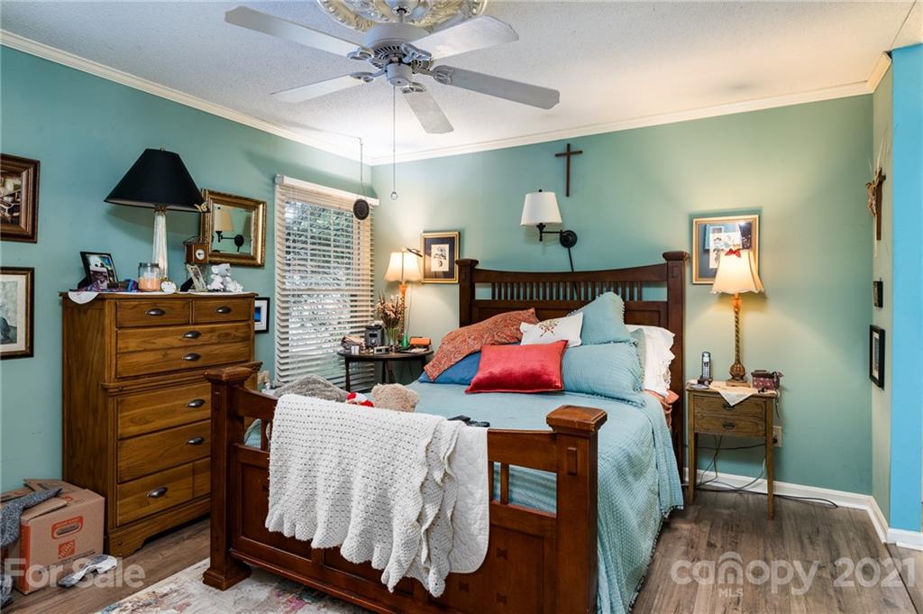 10900 Flat Iron Road Charlotte, NC 28226 - Photo 24 of 44 a living room with furniture and a chandelier