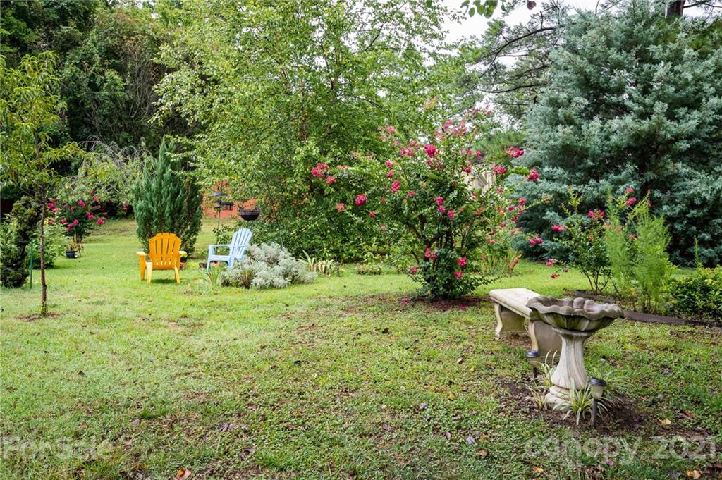 10900 Flat Iron Road Charlotte, NC 28226 - Photo 44 of 44 a garden with a bench and some trees