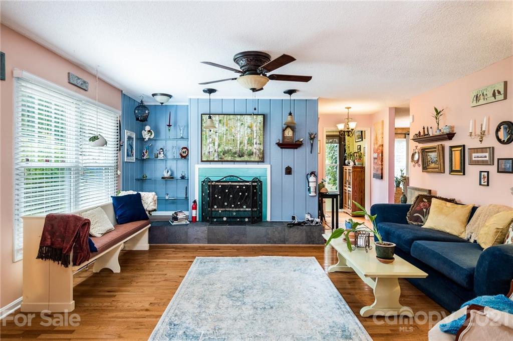 10900 Flat Iron Road Charlotte, NC 28226 - Photo 6 of 44 a living room with furniture a rug and a fireplace