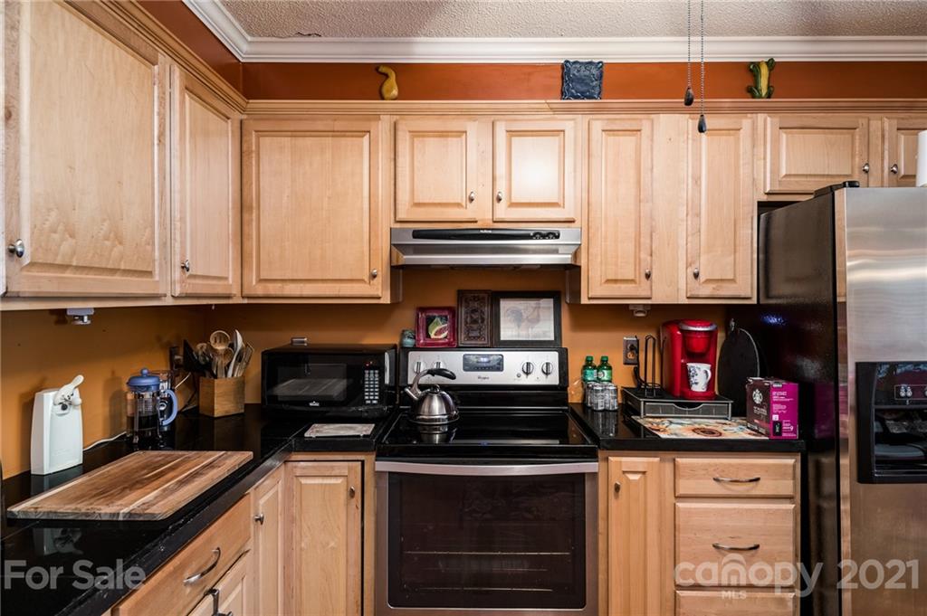 10900 Flat Iron Road Charlotte, NC 28226 - Photo 8 of 44 a kitchen with stainless steel appliances granite countertop a stove and cabinets