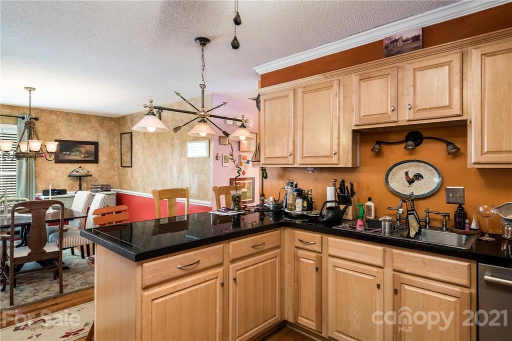 10900 Flat Iron Road Charlotte, NC 28226 - Photo 9 of 44 a kitchen with stainless steel appliances granite countertop a sink a stove and cabinets