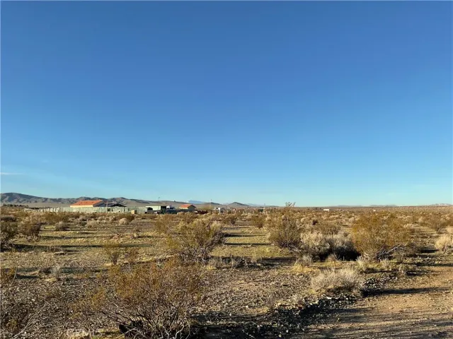 a view of a large building with mountains in the background