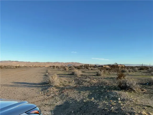 a view of an ocean beach and mountain