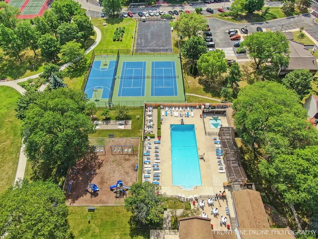 a view of a backyard with swimming pool and furniture