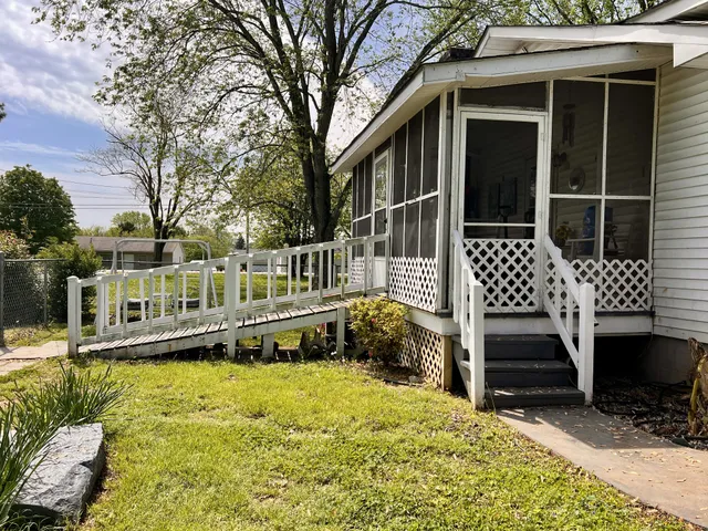 a house that has a tree in front of it