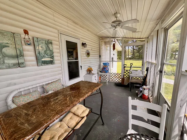 a front view of a house with a garden and trees