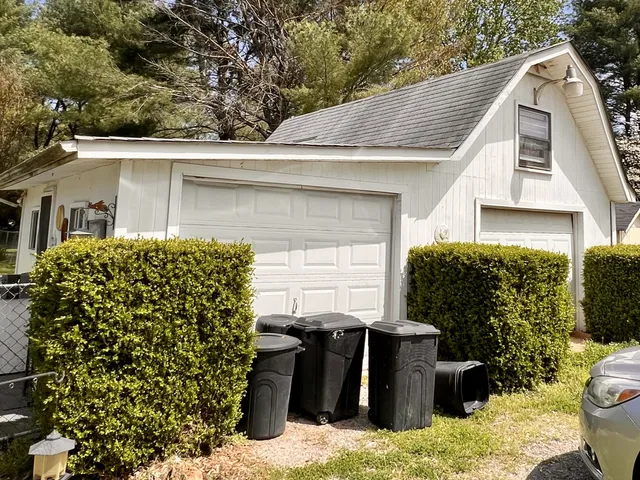 a backyard of a house with table and chairs