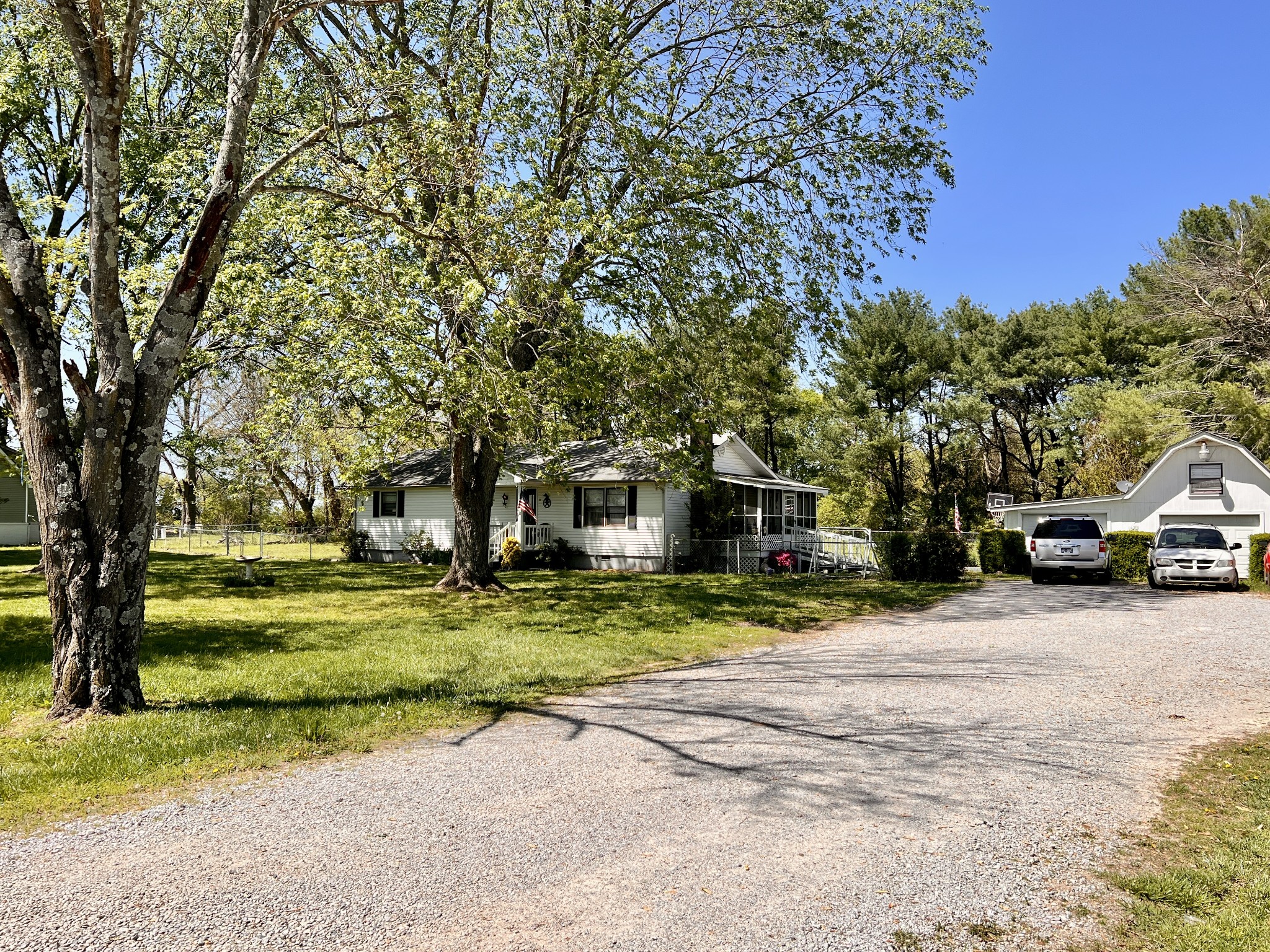 1112 Cumberland Street Decherd, TN 37324 - Photo 5 of 52 a yellow house with trees in front of it
