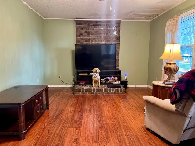a view of a livingroom with furniture and a window