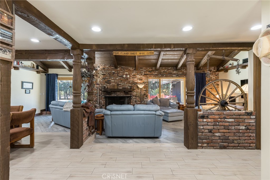 10610 Walnut Drive Shadow Hills, CA 91040 - Photo 16 of 50 a living room with furniture a ceiling fan and a window