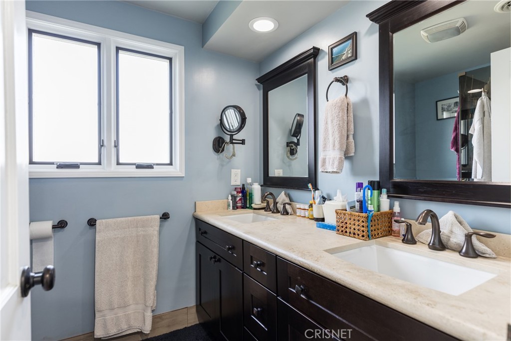 10610 Walnut Drive Shadow Hills, CA 91040 - Photo 22 of 50 a bathroom with a double vanity sink and a mirror