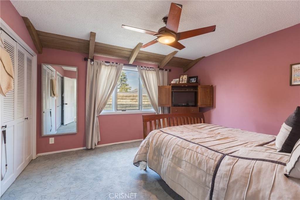 10610 Walnut Drive Shadow Hills, CA 91040 - Photo 23 of 50 a bedroom with a bed and a large window
