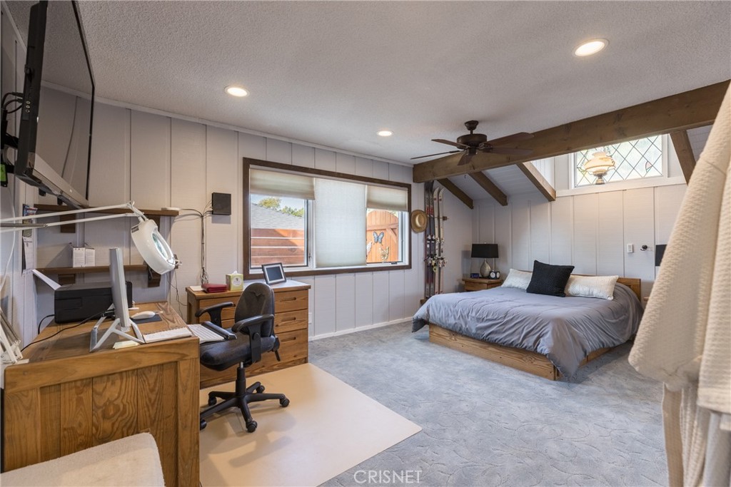 10610 Walnut Drive Shadow Hills, CA 91040 - Photo 25 of 50 a bedroom with a bed gym equipment and large window