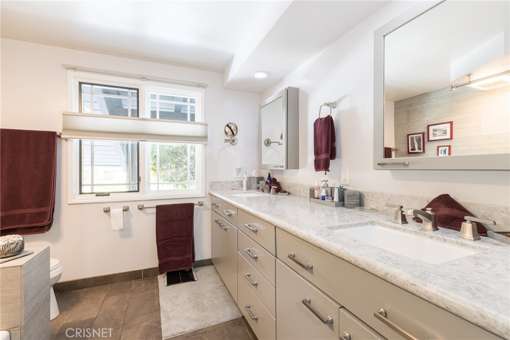 10610 Walnut Drive Shadow Hills, CA 91040 - Photo 29 of 50 a spacious bathroom with a granite countertop sink and a mirror